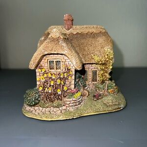 Charming Stone Cottage Figurine with Floral Accents